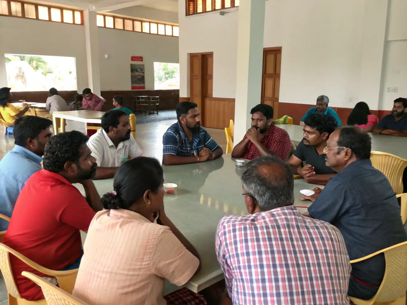 A dynamic image of adults engaged in a lively public debate, highlighting the importance of critical thinking and informed dialogue in a democratic society.